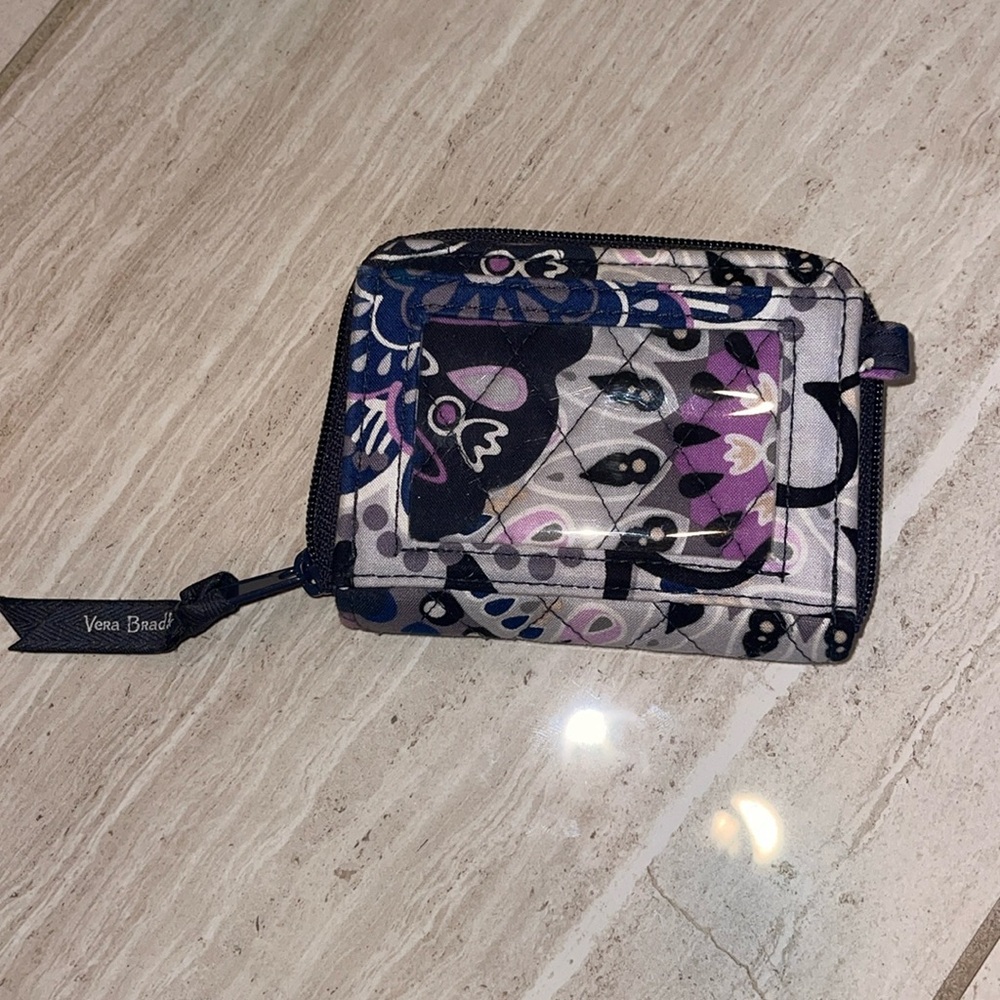 A super convenient purple and white wallet with pretty flowers.